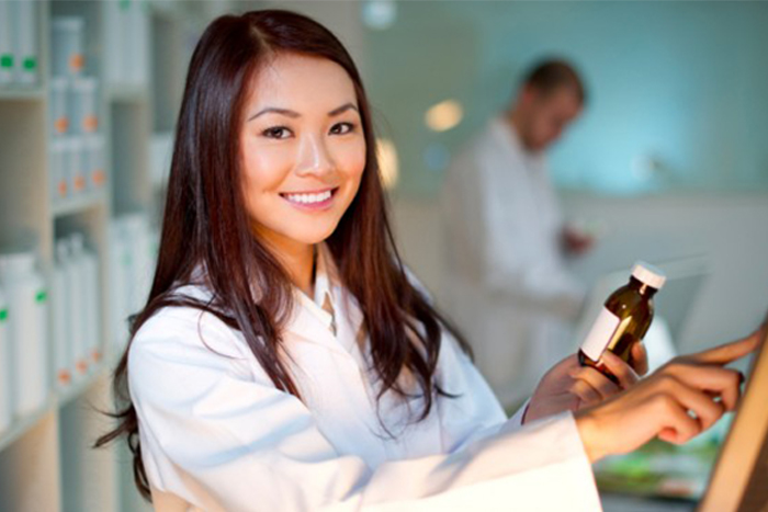 a female pharmacist holding a bottle of pil