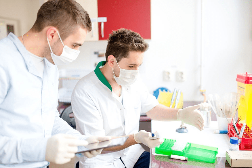 two white male lab assistants working in lab