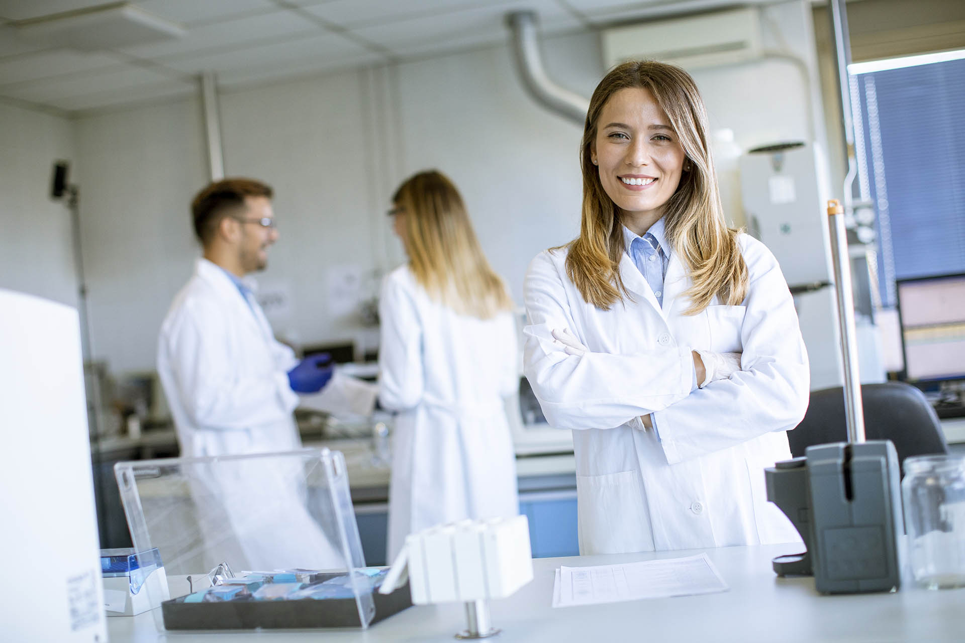 Female scientist in white lab coat standing in the biomedical la